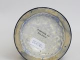 a small blue and white plate with a label on it