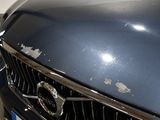 a close up of a car ' s front grill and badge