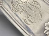 a silver spoon with a design on it on a table