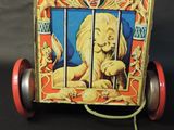 a toy horse pulling a cart with a lion on it