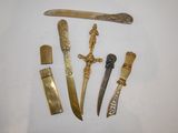 five different types of knives on a white surface