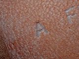 a close up of a brown vase with a number on it
