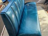 a blue couch that is sitting in the back of a truck