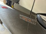 a close up of a car ' s door handle with a ruler on it
