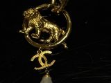gold plated pendant with a white pearl and a lion