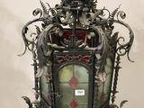 wrought iron hanging light fixture with stained glass panels