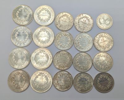 a close up of a pile of silver coins on a table