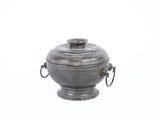 a small metal container with a handle on it