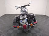 a motorcycle that is parked in a room with a checkered floor