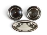 silver plate with two bowls and a spoon on a white surface