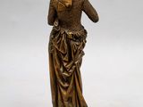 a bronze statue of a woman with a veil on her head