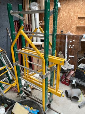 a pile of assorted construction equipment in a garage