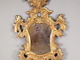 un miroir doré dans lequel se reflète l'image d'un homme