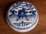 a small blue and white box with a picture of a man on a horse