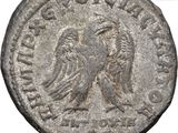 a silver coin with an eagle on the reverse side