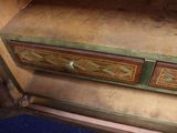 a small wooden desk with two drawers on top of it