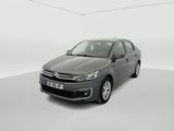a grey car in a white room with a white floor