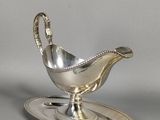 un service en argent ancien composé d'une soucoupe et d'une cuillère
