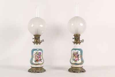 pair of antique porcelain lamps with blue and white flowers on them