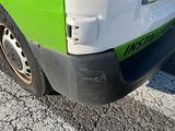 a green and white truck parked on the side of the road