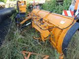 a tractor that is sitting in the grass by itself