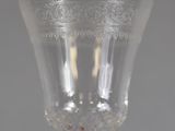 a close up of a wine glass on a table with a gray background