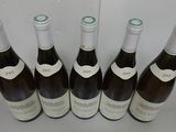six bottles of wine are lined up on a table