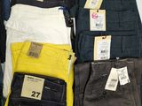 several pairs of men ' s jeans are on display in a store