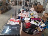 a cart full of clothes and other items in a warehouse