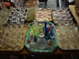 many glasses and trays sitting on a table