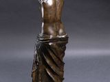 a bronze statue of a woman holding a vase