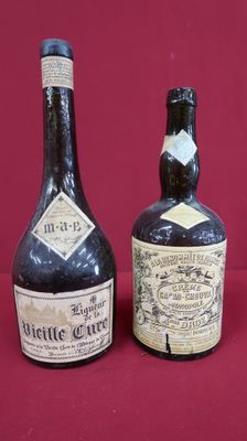 three bottles of wine are lined up on a red surface