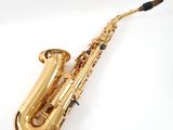 a close up of a golden saxophone on a white background