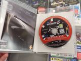 a person holding a video game disc in a store