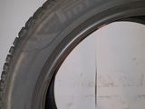 tire on the floor of a garage with a white wall