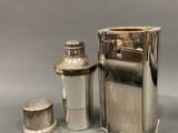 a silver bottle and a lighter sitting next to each other