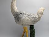 a statue of a bird that is standing on a table