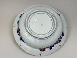 a white plate with blue and red flowers on it