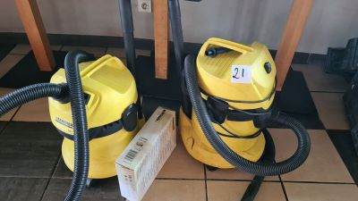 two yellow vacuums sitting on the floor next to each other