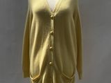the mannequin is wearing a yellow cardigan and a white shirt