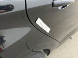 a close up of a car door with a sticker on it