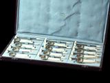 a case that has a bunch of silver spoons in it