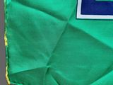 an image of a green cloth with a blue square on it