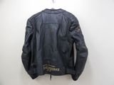 a black leather jacket hanging on a white wall