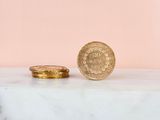 a close up of a gold coin sitting on top of a marble counter