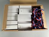 a box with a bunch of white boxes and red, white, and blue ribbons