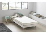 an image of a bed with a mattress and pillows in a room
