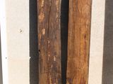two pieces of wood sitting on the ground next to each other