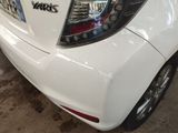 a close up of a white car with a sticker on it