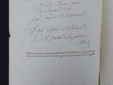 an old book with writing on it sitting on a table